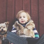 When is the right time to bring a baby and a dog together, and what are some tips for getting them to get along?