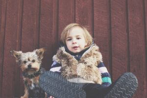 When is the right time to bring a baby and a dog together, and what are some tips for getting them to get along?